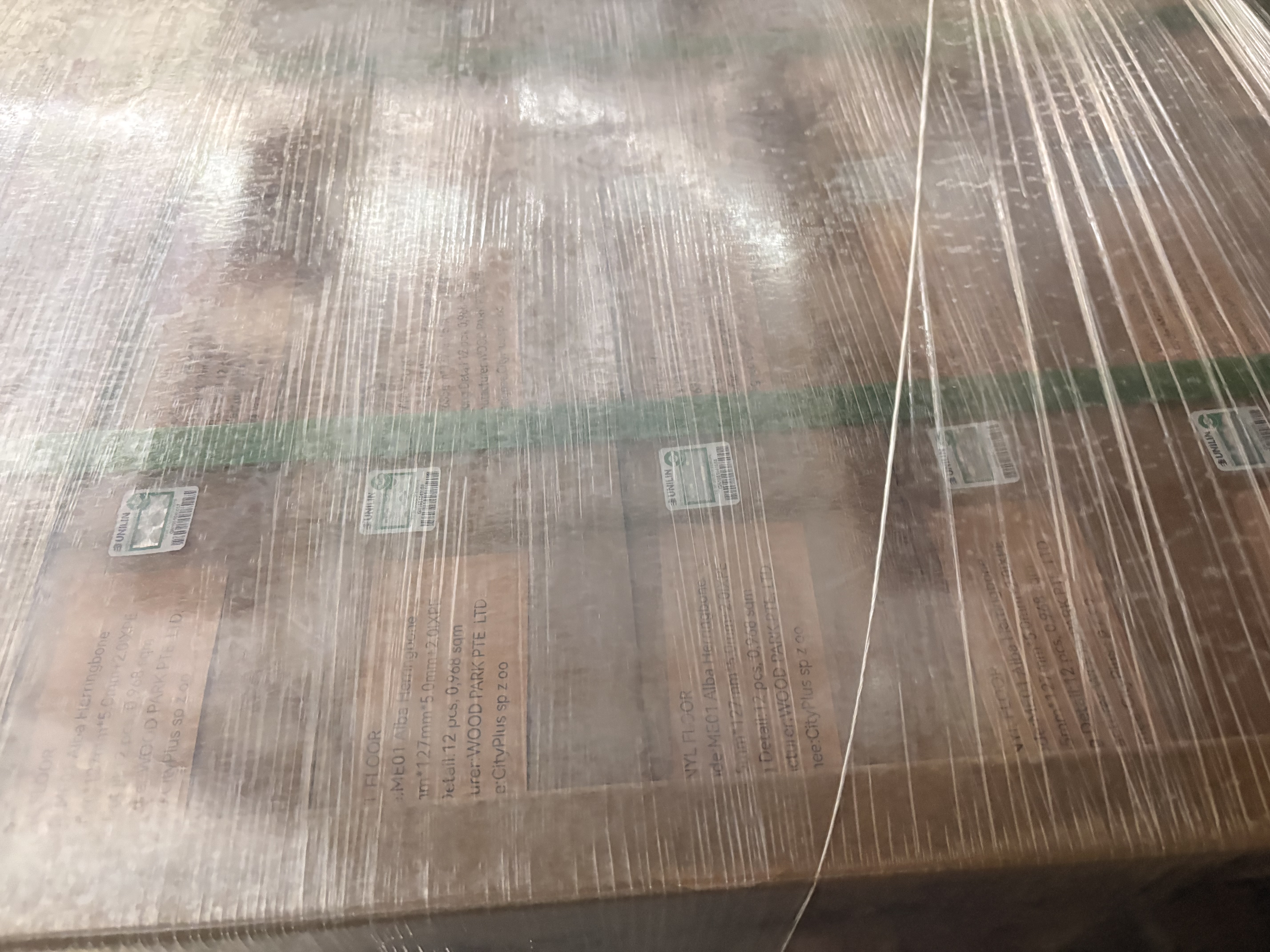 Wrapped pallet of vinyl flooring with full product labels and Unilin certification stickers